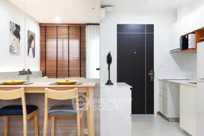 Modern open-plan kitchen and dining area with stylish decor and natural light.