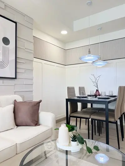 Modern living room with stylish dining area, elegant decor, and contemporary lighting.