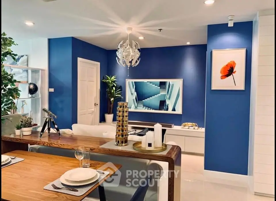 Stylish modern living room with blue accent wall and elegant decor