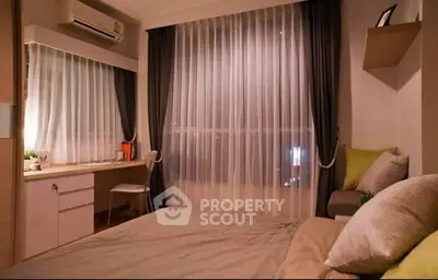 Cozy bedroom with modern decor and large window, featuring a study desk and air conditioning.