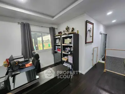 Modern home office with sleek desk, bookshelf, and window view