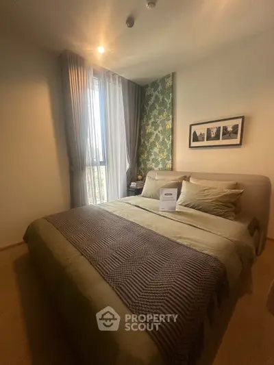 Cozy bedroom with stylish decor and natural light, perfect for relaxation and comfort.