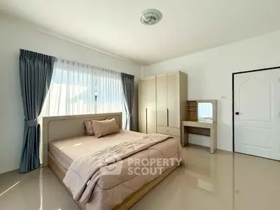 Bright and spacious bedroom with modern furnishings and natural light