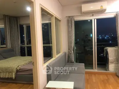 Modern apartment interior with city view, featuring a cozy living area and bedroom with large windows.