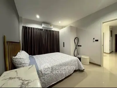 Modern bedroom with stylish decor and ample natural light