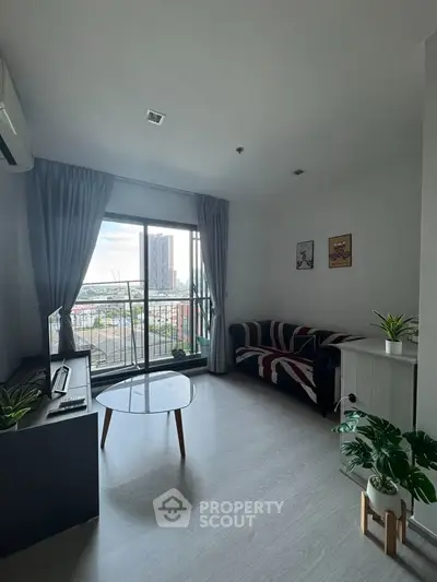Modern living room with city view, stylish decor, and natural light.