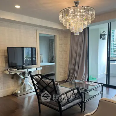 Elegant living room with chandelier and balcony view in luxury apartment