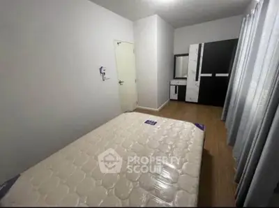 Spacious bedroom with modern wardrobe and natural light, perfect for comfortable living.