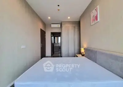 Spacious bedroom with modern decor and ample natural light