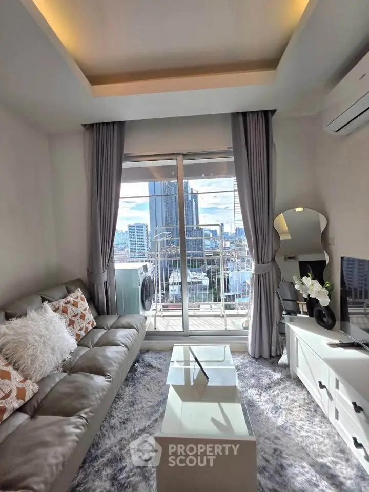 Modern living room with city view and balcony access, featuring stylish decor and natural light.