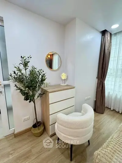 Chic bedroom corner with modern dresser and cozy chair
