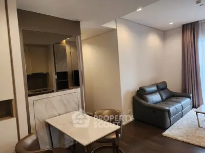 Modern living room with elegant furniture and stylish decor, featuring a cozy sofa and dining area.