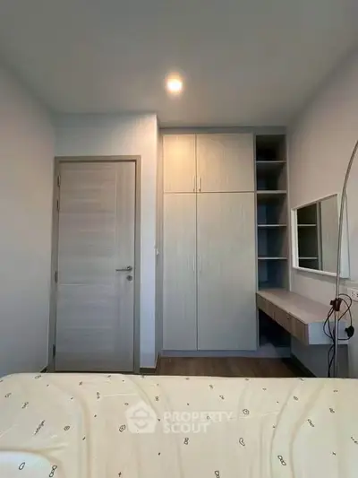 Modern bedroom with built-in wardrobe and stylish vanity desk