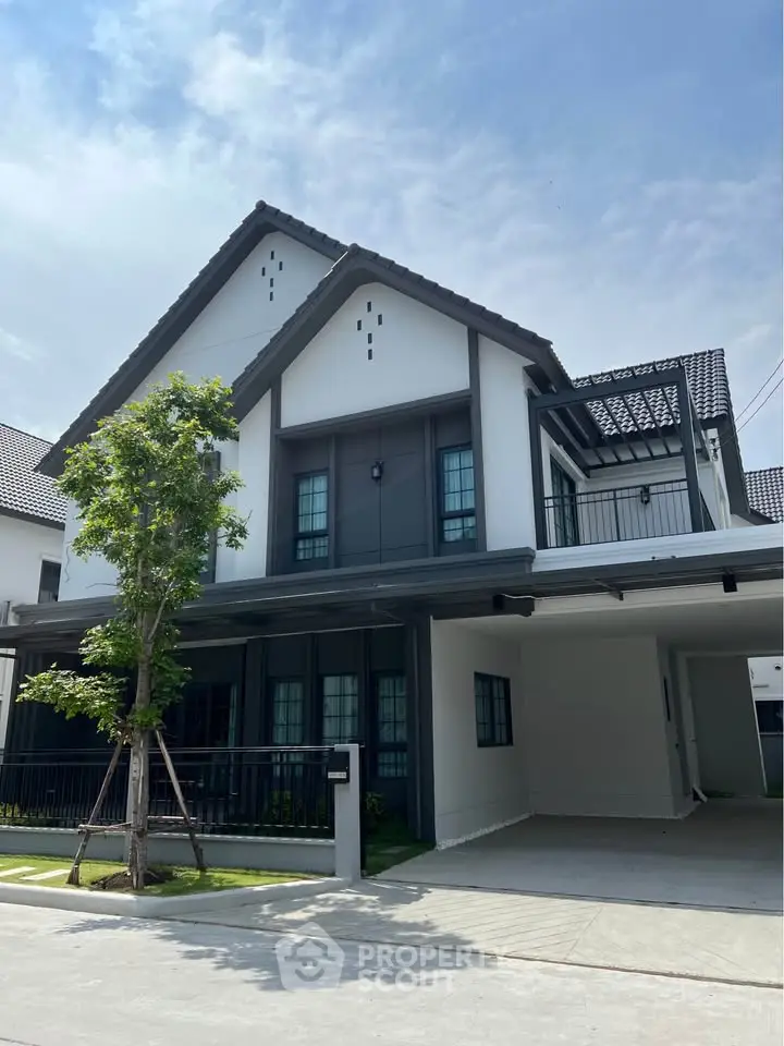 Modern two-story house with sleek design and spacious driveway in a serene neighborhood.
