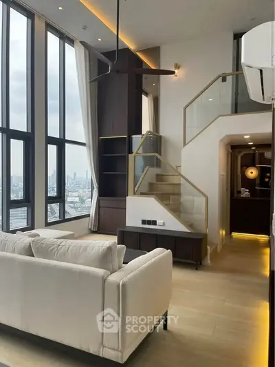 Luxurious high-rise living room with stunning city view and modern staircase