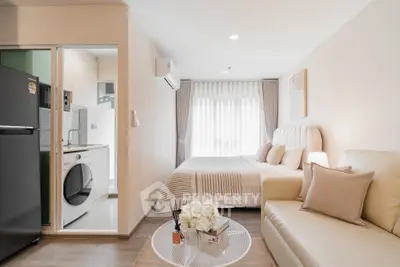 Modern studio apartment with cozy living area and compact kitchen, featuring elegant decor and natural light.