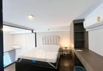 Modern bedroom with sleek design and air conditioning in a stylish apartment.