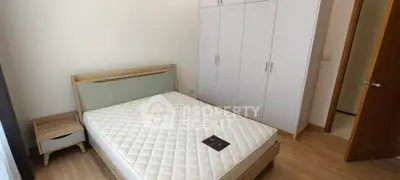 Modern bedroom with sleek wardrobe and minimalist design, perfect for urban living.