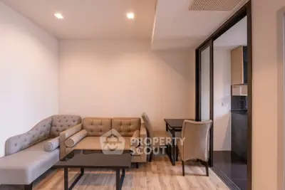 Modern living room with elegant furniture and open kitchen layout in a stylish apartment.