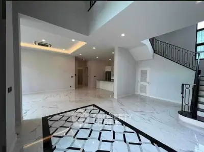 Spacious modern living room with elegant staircase and marble flooring