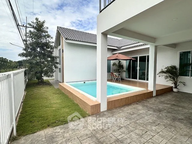 Modern home with private pool and spacious patio, perfect for outdoor relaxation.