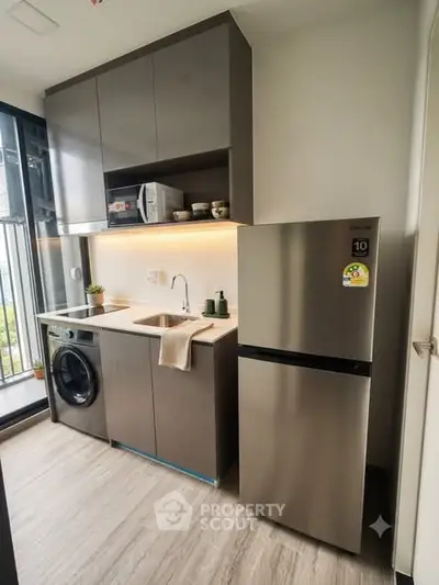 Modern kitchen with sleek appliances and open layout in urban apartment