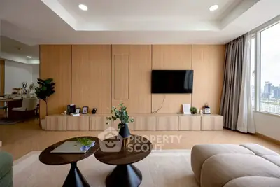 Modern living room with wooden paneling, stylish furniture, and city view.