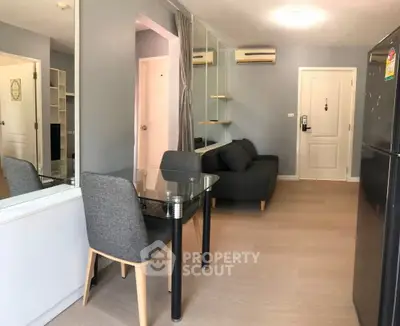 Modern apartment interior with sleek furniture and air conditioning, showcasing a cozy living and dining area.