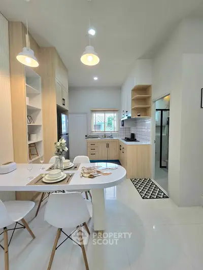 Modern kitchen with open layout, sleek cabinetry, and stylish dining area.