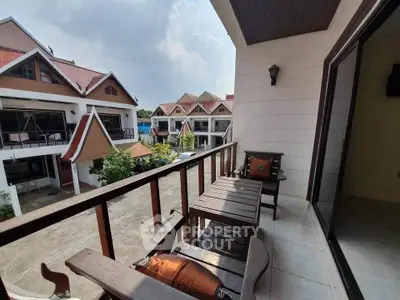 Charming balcony view in a serene residential area with traditional architecture.
