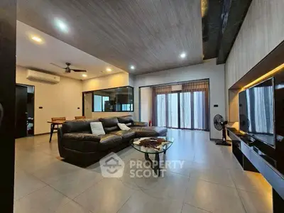 Spacious modern living room with sleek design and large windows for natural light.