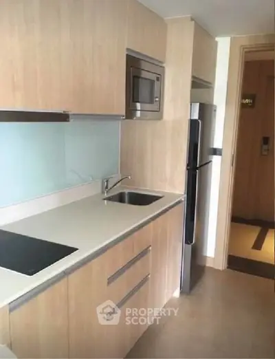 Modern kitchen with sleek cabinetry and built-in appliances in a stylish apartment.