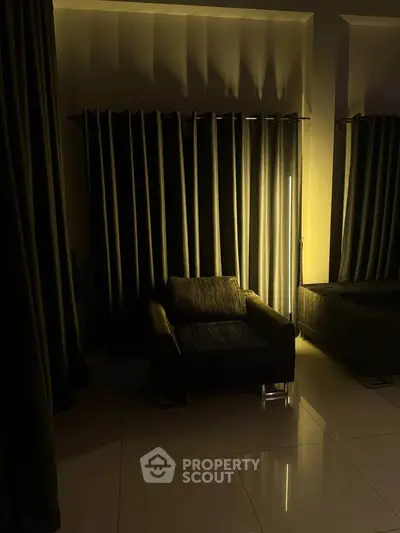 Cozy living room with modern armchair and ambient lighting