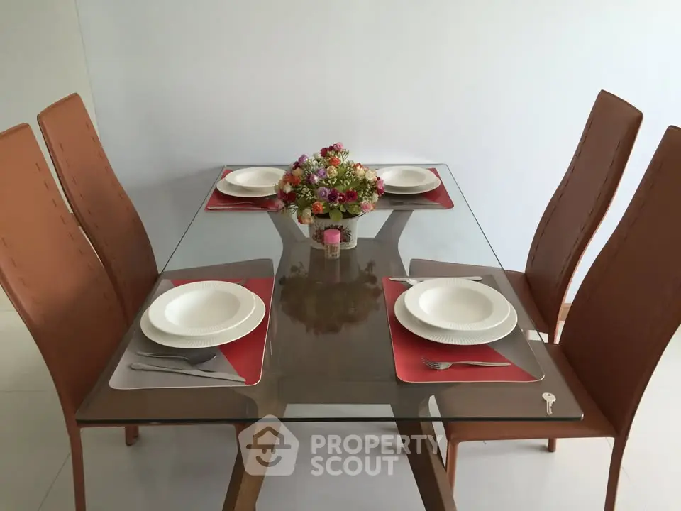 Elegant dining area with glass table and modern chairs, perfect for stylish home dining.