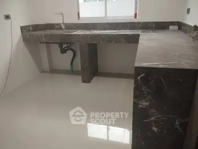 Modern kitchen with sleek marble countertops and open layout design