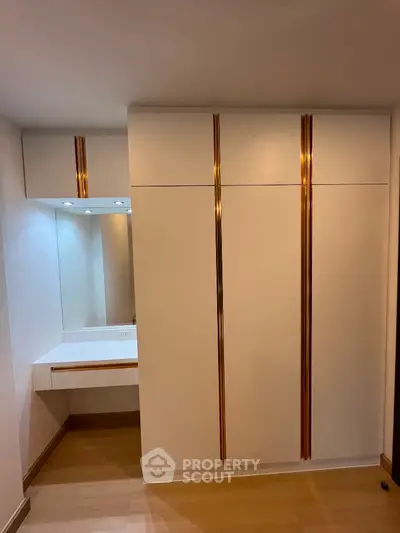 Modern bedroom with elegant built-in wardrobe and vanity area