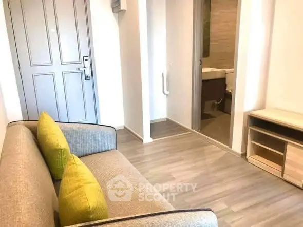 Modern apartment interior with cozy sofa and open bathroom view