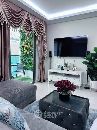 Luxurious living room with elegant decor and wall-mounted TV, featuring a lush vertical garden view.