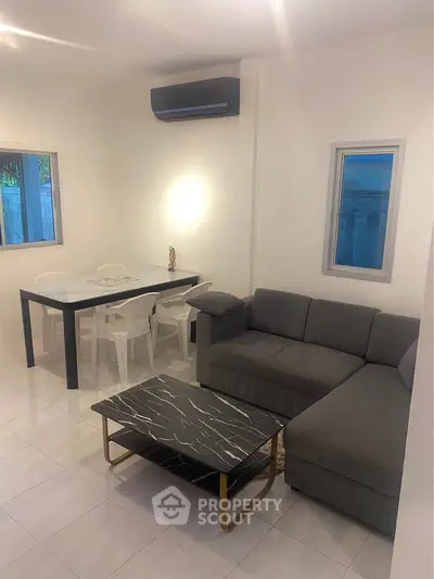 Modern living room with sleek furniture and stylish decor in a cozy apartment setting.