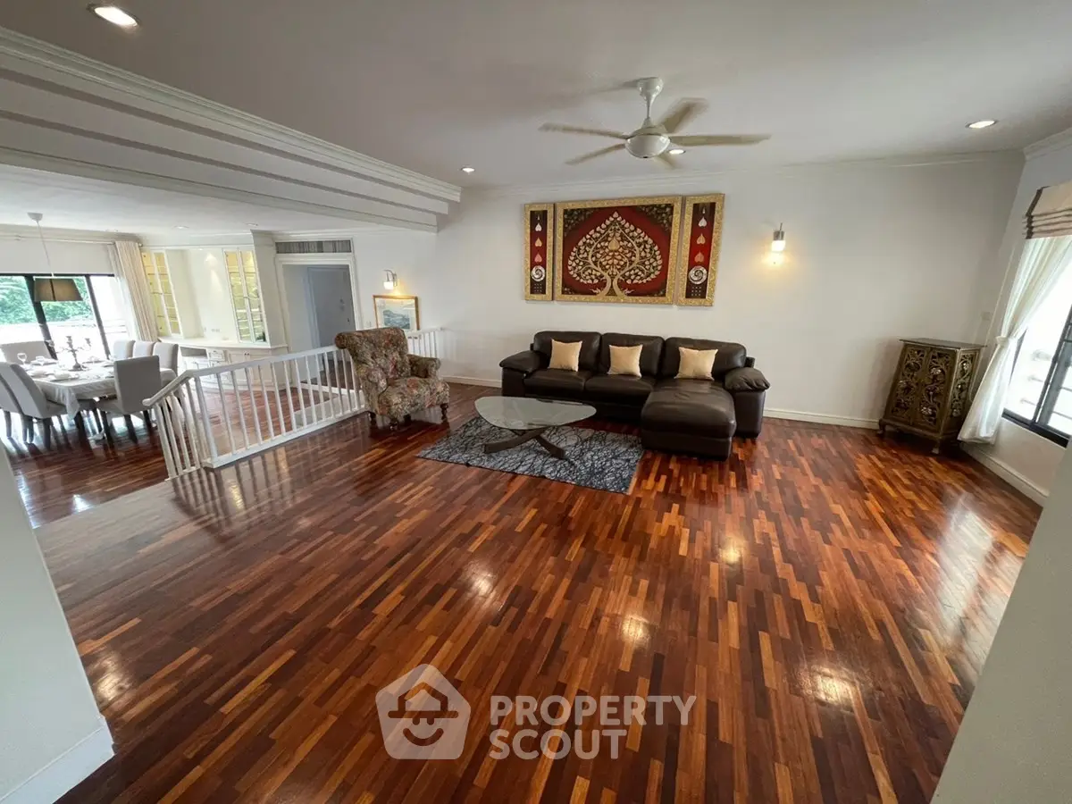 Spacious living room with elegant wooden flooring and stylish decor