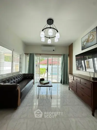 Spacious living room with modern decor and large windows for natural light.