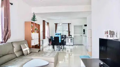 Spacious living room with modern decor and dining area in open layout.