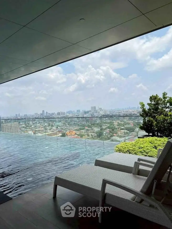 Luxurious rooftop pool with stunning city skyline view and relaxing lounge chairs.