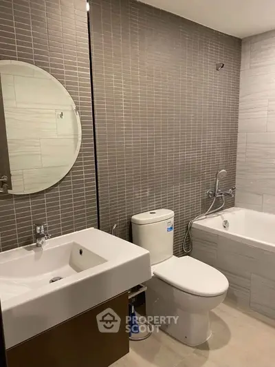 Modern bathroom with sleek fixtures and bathtub in contemporary apartment.