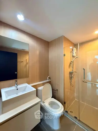 Modern bathroom with sleek fixtures and glass shower enclosure