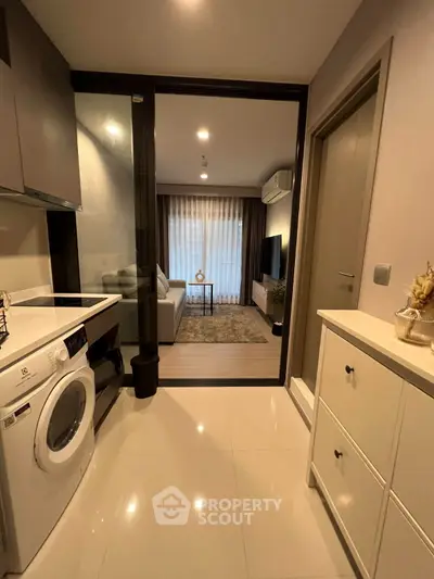 Modern apartment interior with washing machine and cozy living room view