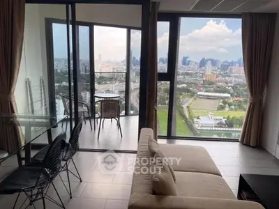Spacious living room with stunning city view and large balcony access.