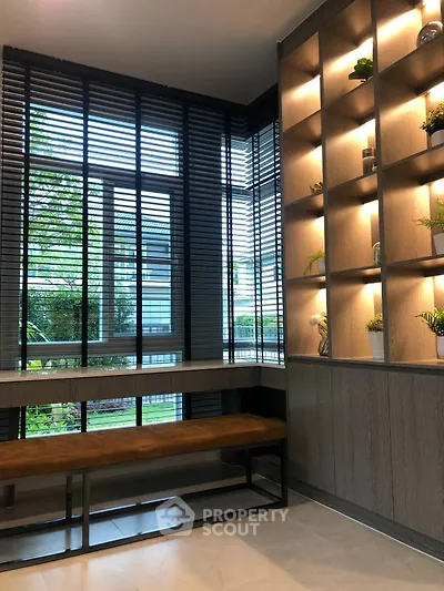 Modern interior with stylish shelving and large windows in a contemporary living space.