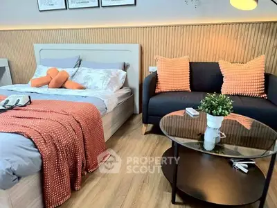 Modern bedroom with cozy bed, stylish sofa, and elegant decor