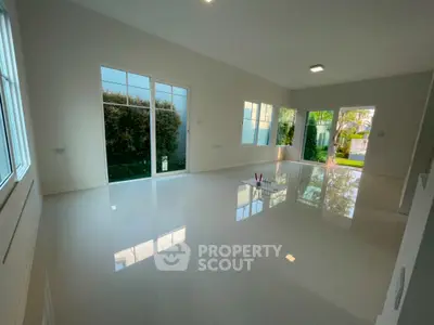 Spacious modern living room with large windows and garden view